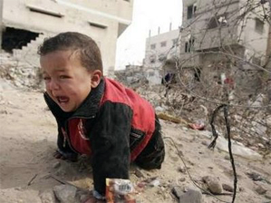 Baby Gazan boy crying amidst rubble